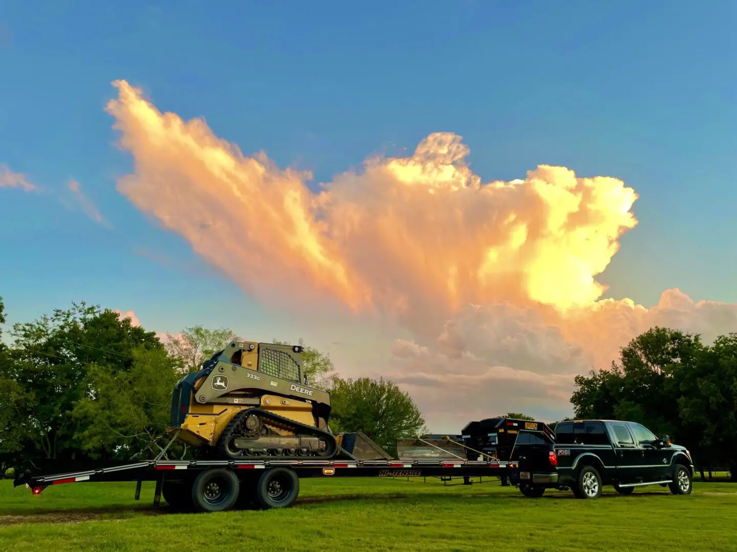 A Truck With an Excavator Under the Golden Sky