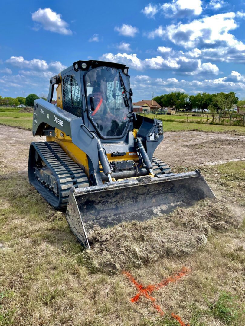 Excavation of a Grassy Land With Marking With an Excavator